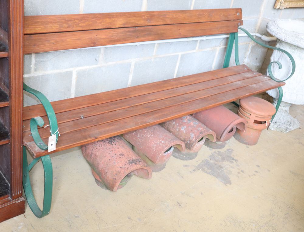 A wrought iron and slatted pine garden bench, W.195cm, D.60cm, H.84cm